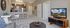 Chic open-concept apartment living room with modern kitchen, featuring sleek appliances and stylish decor.