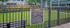 Inviting apartment community dog park with lush green grass and secure fencing, offering a lively and pet-friendly environment.