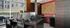 Chic and modern office space with sleek desks, stylish chairs, and large windows offering a view of the pool.