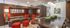 Luxurious modern living room featuring rich wooden accents, plush red seating, and a stylish dining area with vibrant greenery.