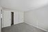 Bright, spacious room with plush carpeting, large closet space, and natural light streaming through the window.