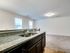 Bright open-concept kitchen with elegant granite countertops and spacious living area.