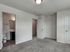 Bright and inviting bedroom featuring plush carpet and a modern ensuite bathroom.