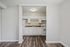 Bright and modern kitchen with white cabinetry, sleek countertops, and elegant flooring, perfect for a stylish apartment living.