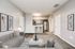 Contemporary open-concept apartment with sleek kitchen and cozy living area, perfect for relaxation and entertaining.