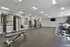 Modern fitness center with state-of-the-art gym equipment, bright lighting, and open space for workouts.