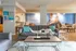 Chic living room with modern furnishings and nautical wall art, offering a cozy and inviting ambiance.