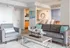 Modern living room featuring elegant gray seating, contemporary art, and a chic cityscape view, perfect for urban living.