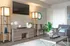 Contemporary living room featuring chic decor with a wall-mounted TV, stylish wooden shelving, elegant sculptures, and a plush armchair, offering a serene and inviting atmosphere.
