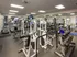 Well-equipped fitness center featuring modern cardio machines, free weights, and strength training equipment.