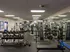 Spacious fitness center equipped with modern weight machines, free weights, and mirrored walls for optimal workouts.