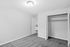 Bright, inviting room with a clean white wall, plush carpet, and spacious built-in closet, perfect for modern living.