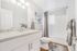Elegant bathroom with modern fixtures, stylish granite countertop, and soothing gray tones, creating a serene atmosphere.
