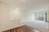 Bright and inviting open-concept living space with elegant hardwood floors and expansive balcony views.