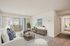 Bright living room with modern decor, plush carpet, balcony view, perfect for relaxing at the Reserve at Sawmill.
