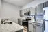 Modern kitchen with sleek granite countertops, stainless steel appliances, and elegant grey cabinetry.