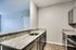 Modern kitchen featuring sleek granite countertops, stainless steel appliances, and elegant cabinetry, perfect for a stylish cooking experience.