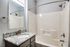 Contemporary bathroom with sleek granite countertop and modern fixtures, ideal for stylish living.