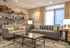 Elegant living room with gray sofas, stylish coffee table, and ambient lighting, ideal for relaxation and gatherings.