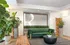 Inviting lobby of The Redwood with elegant decor, green sofa, modern furnishings, and lush plants for a warm welcome.