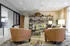 Chic modern lounge area with plush seating, elegant lighting, and decorative shelving exudes comfort and style.