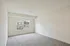Bright and airy bedroom with new carpeting and a large window offering natural light and scenic views.