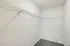 Spacious walk-in closet with sleek wire shelving, perfect for organized storage and a clutter-free lifestyle.