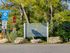 Entrance sign for Lake Roland Park, located near Twin Ridge Apartments, welcoming visitors to the park.