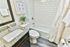 Elegant bathroom with modern fittings, featuring a granite countertop, sleek fixtures, and a stylish subway tile bathtub surround.