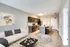 Modern open-concept living area with a stylish kitchen, cozy seating, and elegant decor, perfect for entertaining.