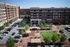 Vibrant urban complex featuring modern apartments, popular eateries, and landscaped communal spaces with lush greenery.