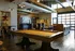 Luxurious open-concept lounge featuring a modern pool table, elegant seating, and vibrant artwork for a perfect gathering space.