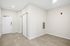 Chic apartment entryway featuring sleek sliding doors, elegant neutral walls, and modern recessed lighting.
