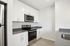 Sleek modern kitchen featuring stainless steel appliances, elegant white cabinetry, and minimalist design.