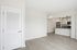Modern apartment interior featuring an open-concept kitchen with sleek cabinetry, stainless steel appliances, and elegant pendant lighting.