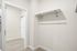 Sleek and modern walk-in closet with ample hanging space and contemporary design, perfect for organizing your wardrobe.