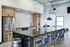 Gourmet kitchen in the clubhouse with island seating at Model Tobacco Lofts.