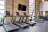 Gym stocked with three treadmills and smith machine at Model Tobacco Lofts in Richmond.