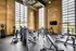 Exercise room with equipment and spacious window at Model Tobacco Lofts.