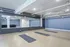 A serene yoga room with mirrors and wooden floors, perfect for finding balance and inner peace at Model Tobacco Lofts.