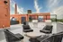 Seating for residents on rooftop terrace next to two grill stations at Model Tobacco Lofts.
