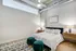 Bedroom with large bed and hardwood floors at Model Tobacco Lofts.