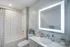 LED backlit mirror above bathroom vanity at Model Tobacco Lofts.