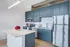 Blue cabinet kitchen with white quartz countertop at Model Tobacco Lofts.