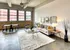 Model Tobacco Lofts living room with a comfy couch, a coffee table, and chairs for relaxation and gatherings.