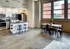 A modern kitchen and dining area in an industrial building, featuring sleek design at Model Tobacco Lofts.