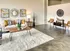 Inviting living room with white rug and plush couch at Model Tobacco Lofts.
