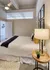 Simple bedroom decor with bed, nightstand, and ceiling fan at Model Tobacco Lofts.