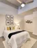 Model Tobacco Lofts bedroom with a comfy bed, a nightstand, and a ceiling fan to keep you cool and relaxed.