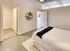 Model Tobacco Lofts bedroom with a comfy bed, a stylish dresser, and a ceiling fan to keep you cool and relaxed.